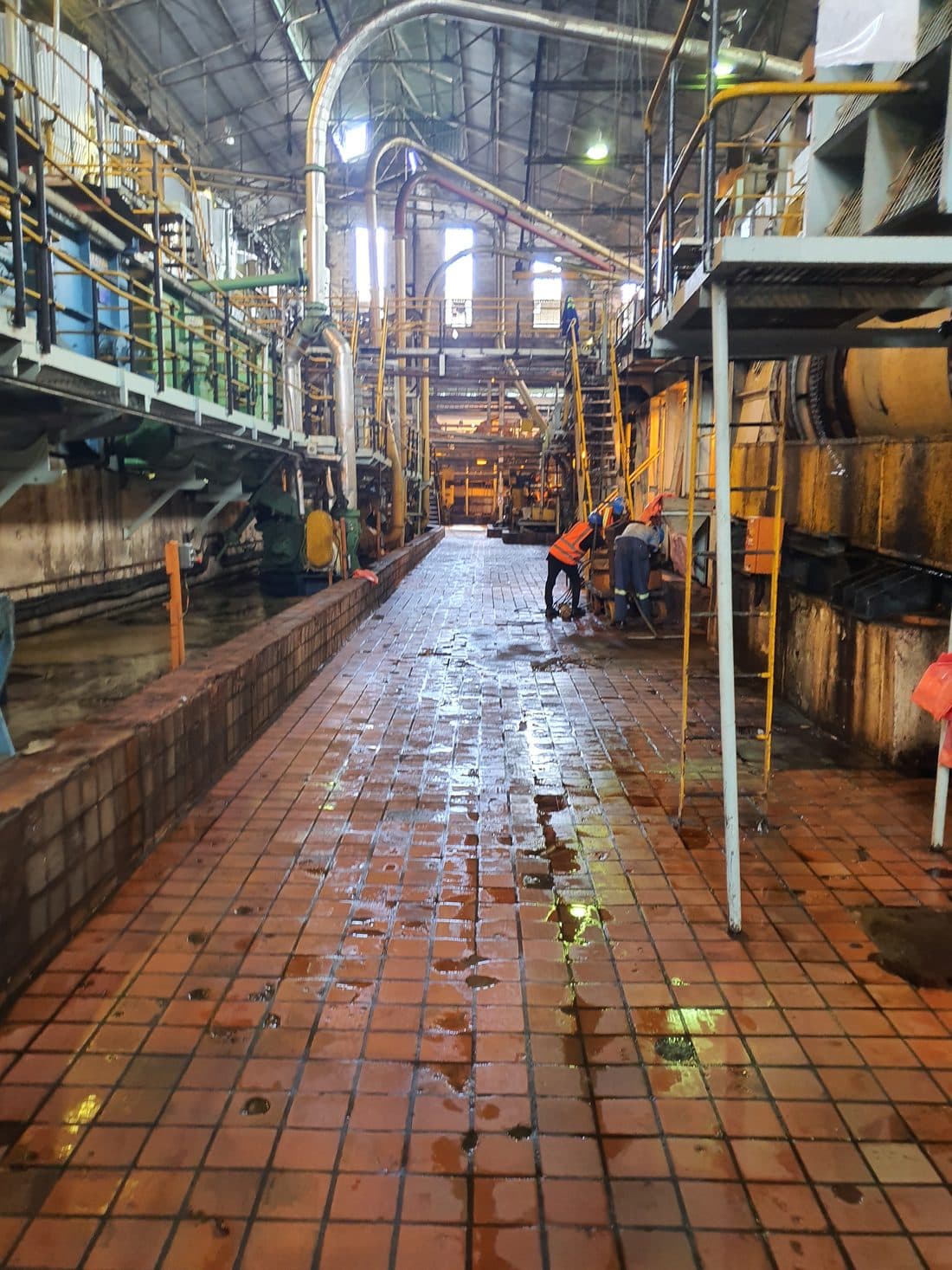 Walkway beside a brick-lined industrial kiln